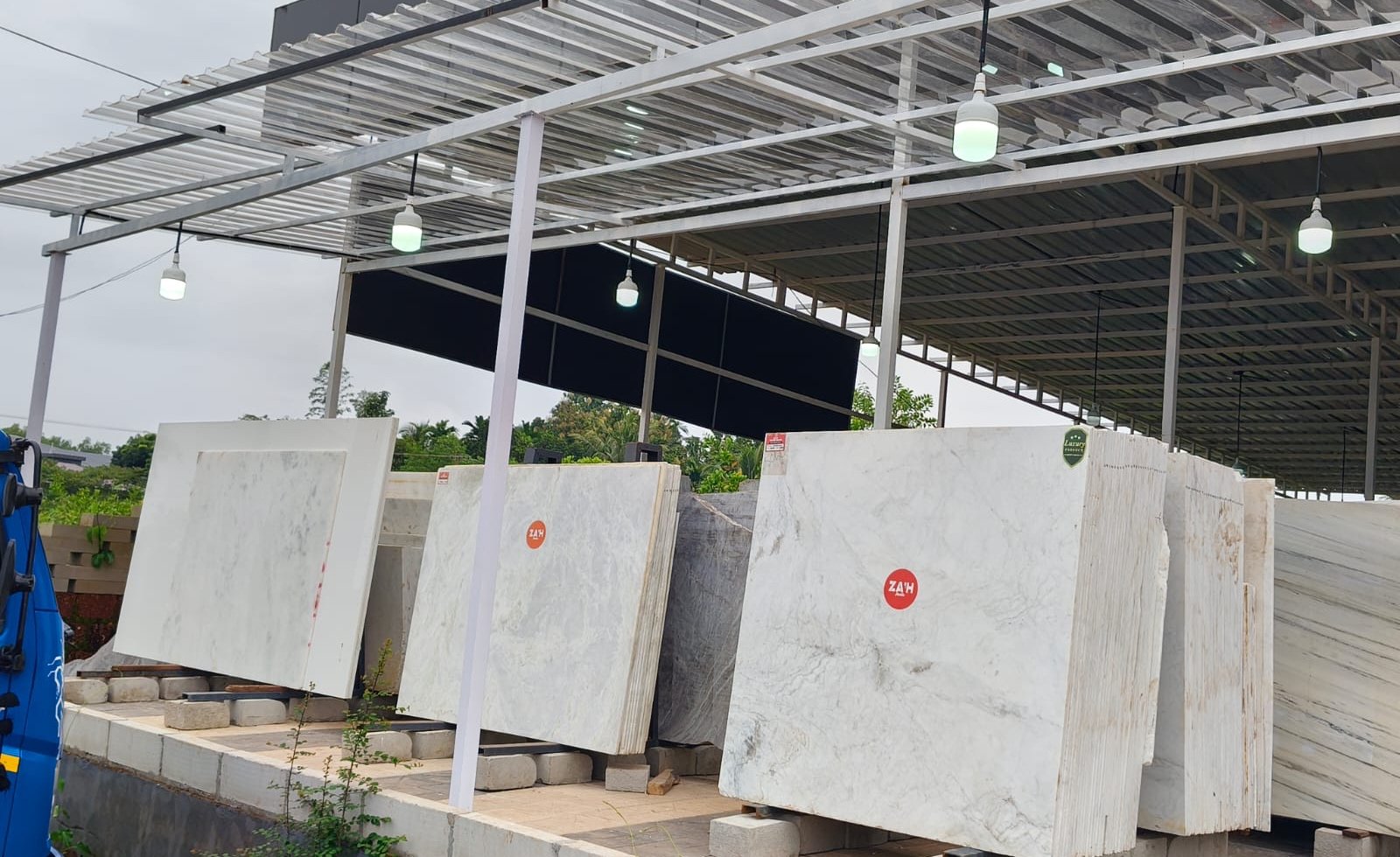 Marble slabs standing on the racks under the shed roof